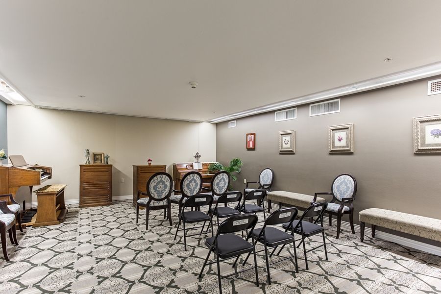 A small, well-decorated meeting room with patterned tiles and chairs arranged facing a podium.