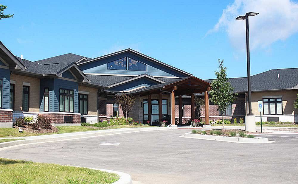 A modern commercial building with a prominent entrance and landscaped surroundings.
