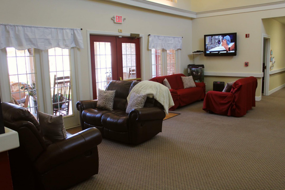 Cozy living room with comfortable seating and a wall-mounted TV.