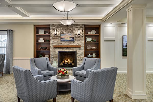 A cozy living room with a modern fireplace and comfortable seating arrangement.