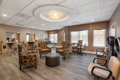 A stylish waiting room with comfortable seating and elegant lighting.