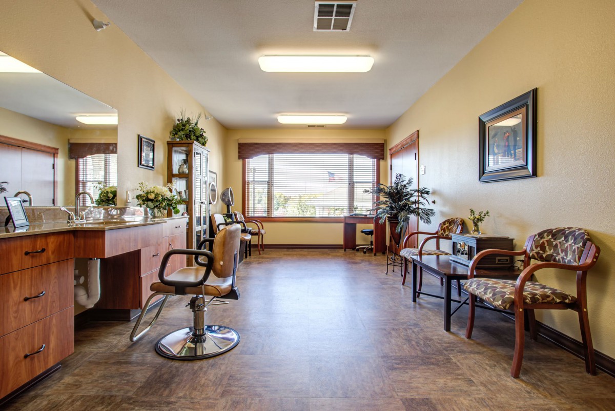 A bright and inviting salon interior with chairs, mirrors, and a waiting area.