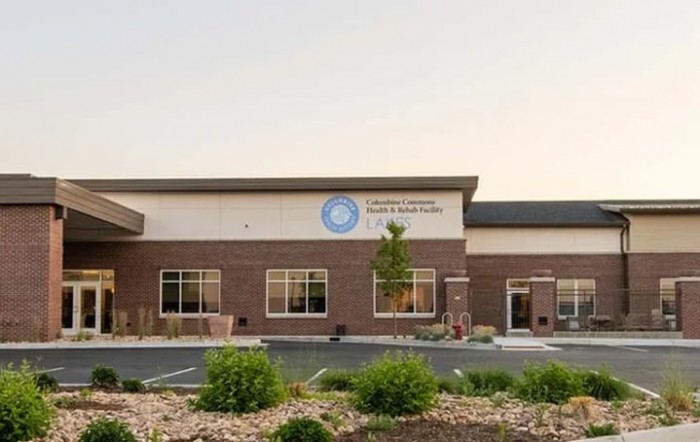 The exterior of a modern medical clinic building under clear skies.