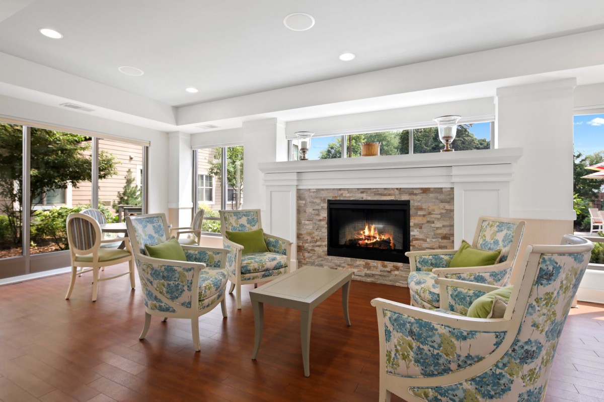A cozy living room with a fireplace and comfortable seating.