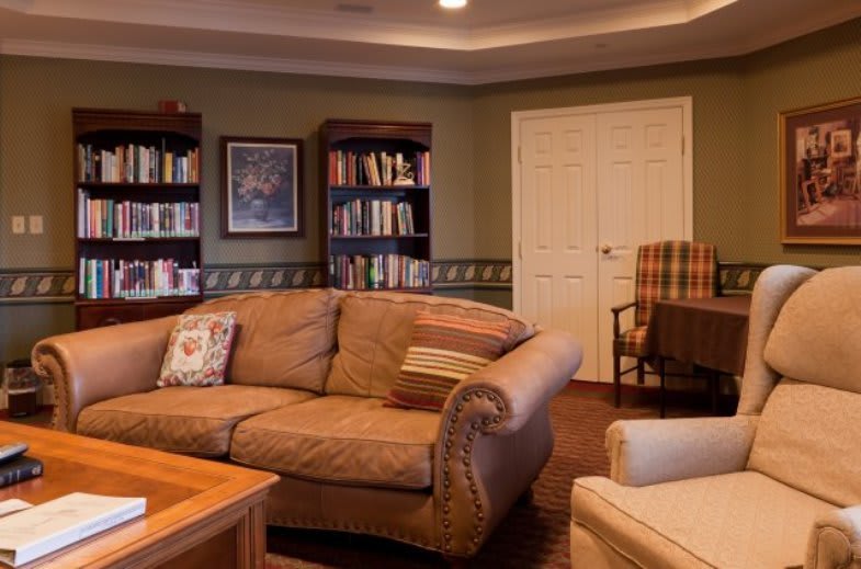 A cozy living room with a comfortable sofa and bookshelves.