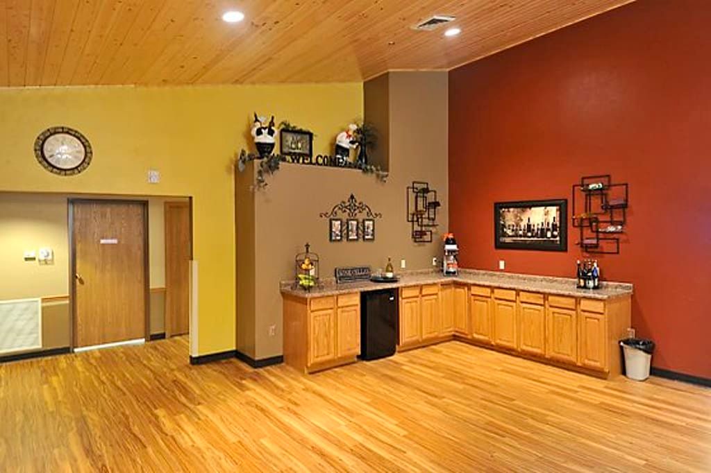 Spacious kitchen with wooden cabinets and bright decor.
