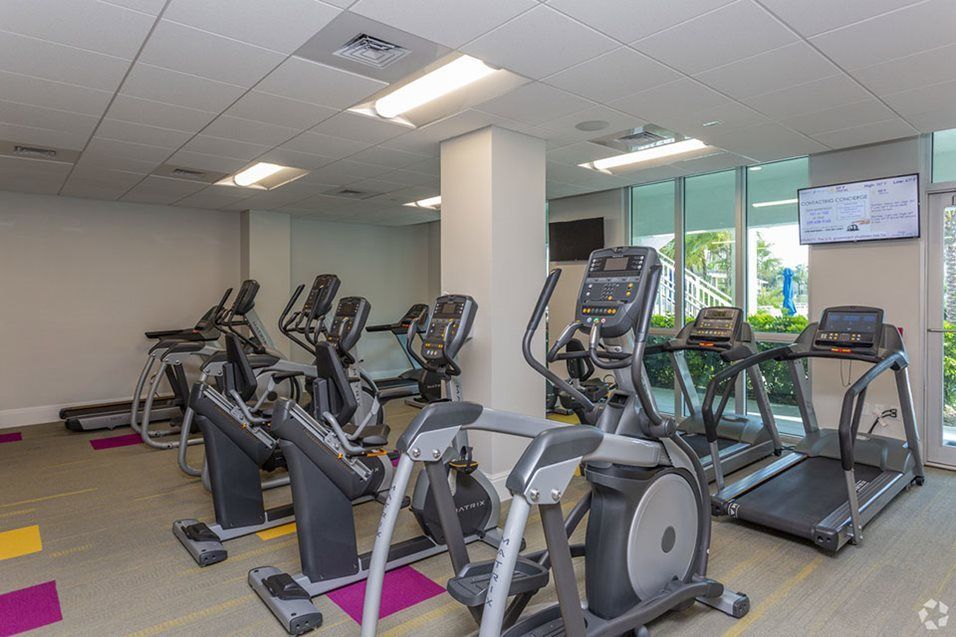 A modern gym equipped with multiple elliptical machines for cardio workouts.