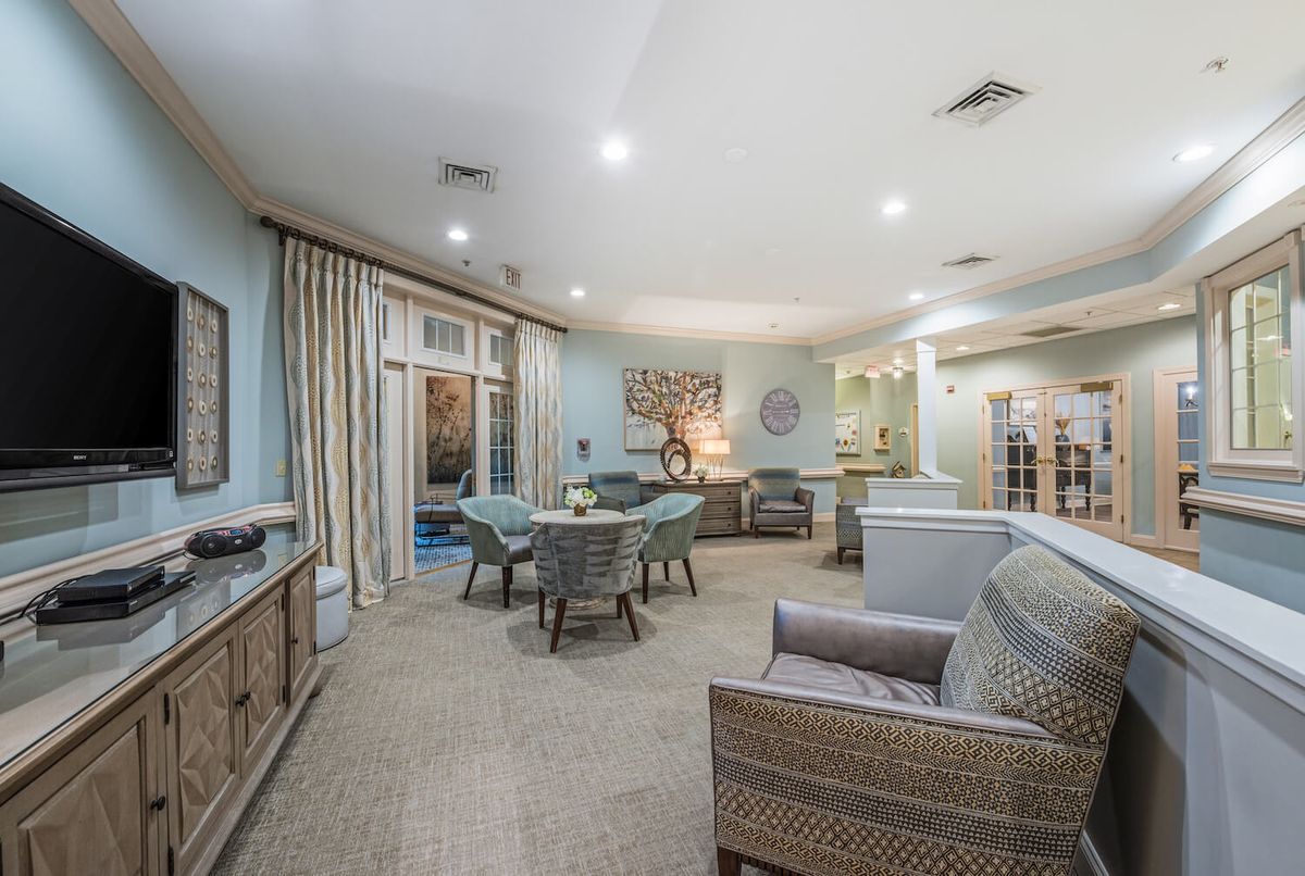 A spacious and modern living room with comfortable seating and stylish decor.