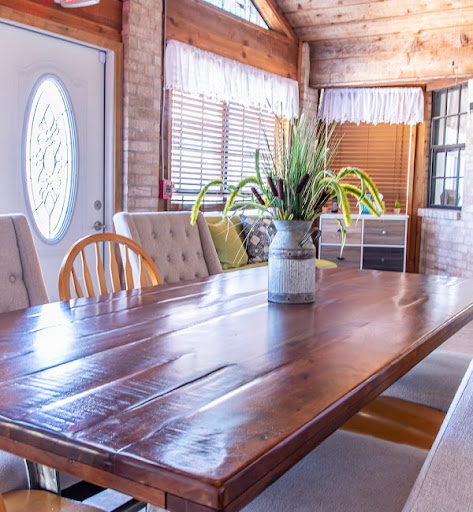 A warm and inviting dining room featuring a large wooden table and natural decor.