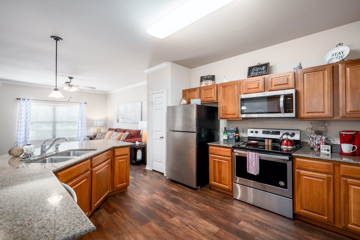 A modern kitchen with wooden cabinets and stainless steel appliances.
