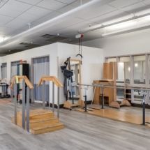 A modern gym interior featuring various fitness equipment.