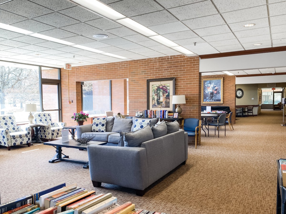 A cozy library interior featuring comfortable seating and bookshelves.
