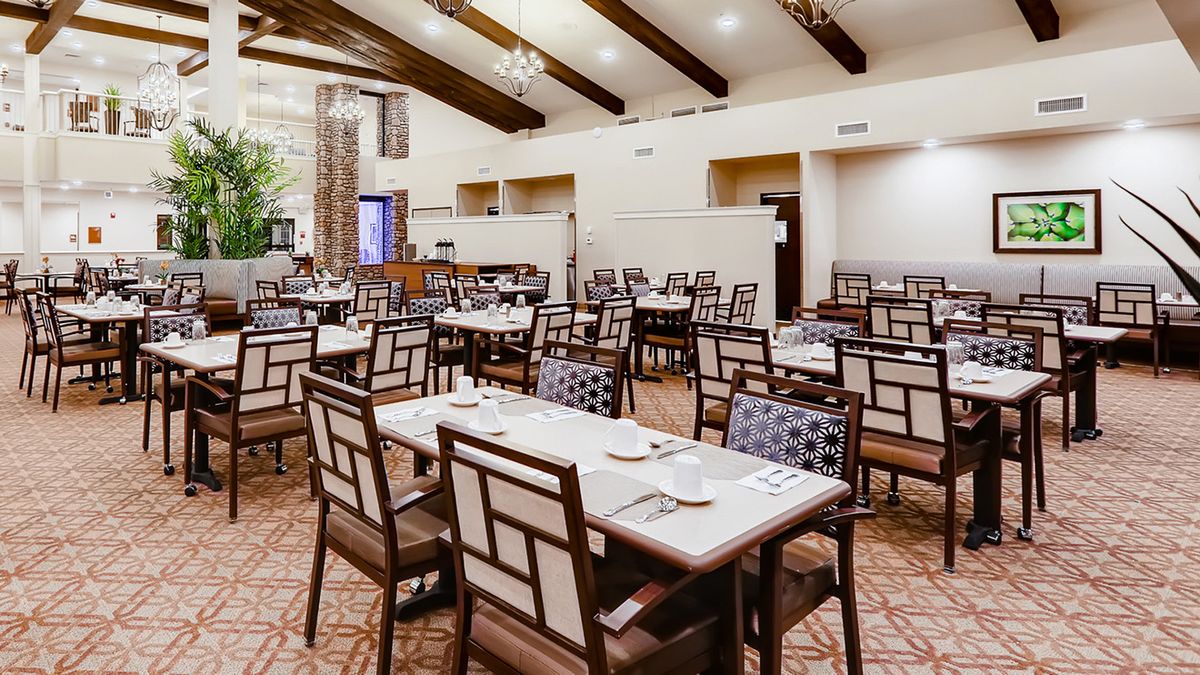 An elegant restaurant interior with neatly arranged tables and chairs in a spacious dining area.