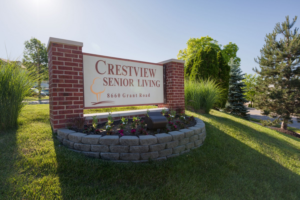 Crestview Senior Living sign surrounded by well-maintained landscaping.