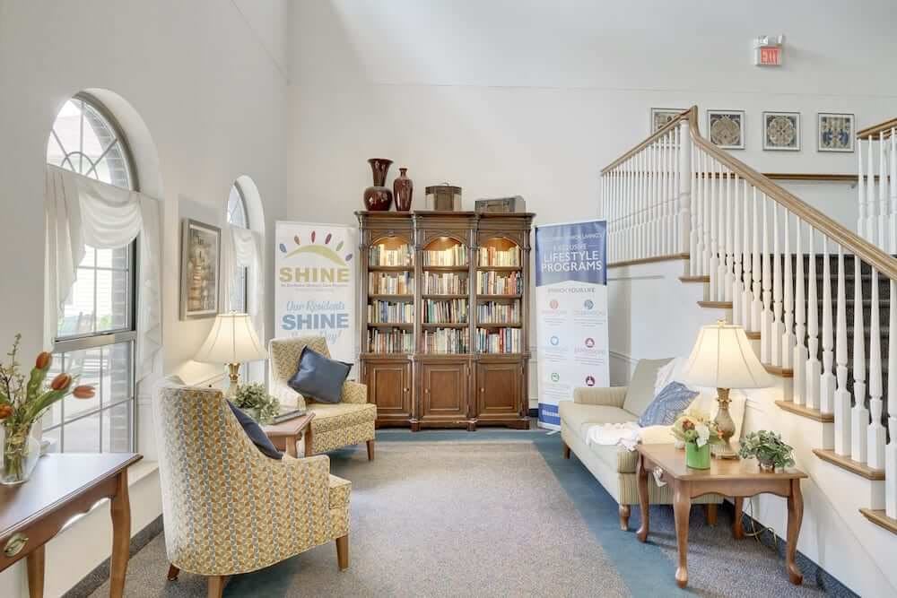 A cozy living room with a large bookshelf and comfortable seating.