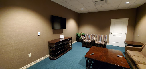 A cozy waiting area featuring comfortable seating and a television.