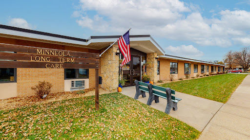 Entrance to the local community center featuring an American flag and seating area.