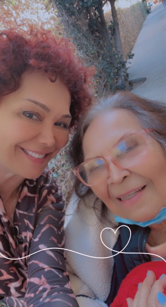 Two women smiling together for a selfie.