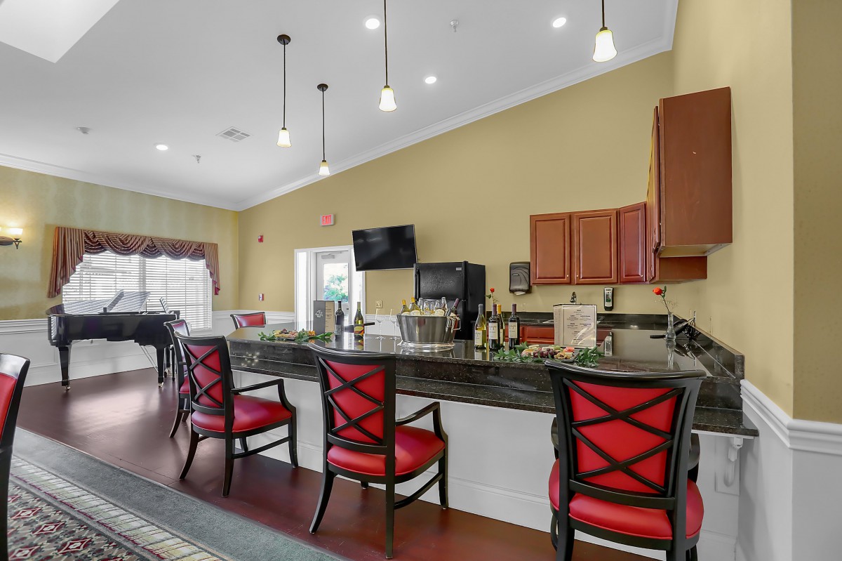 A modern kitchen area with bar seating and stylish pendant lighting.