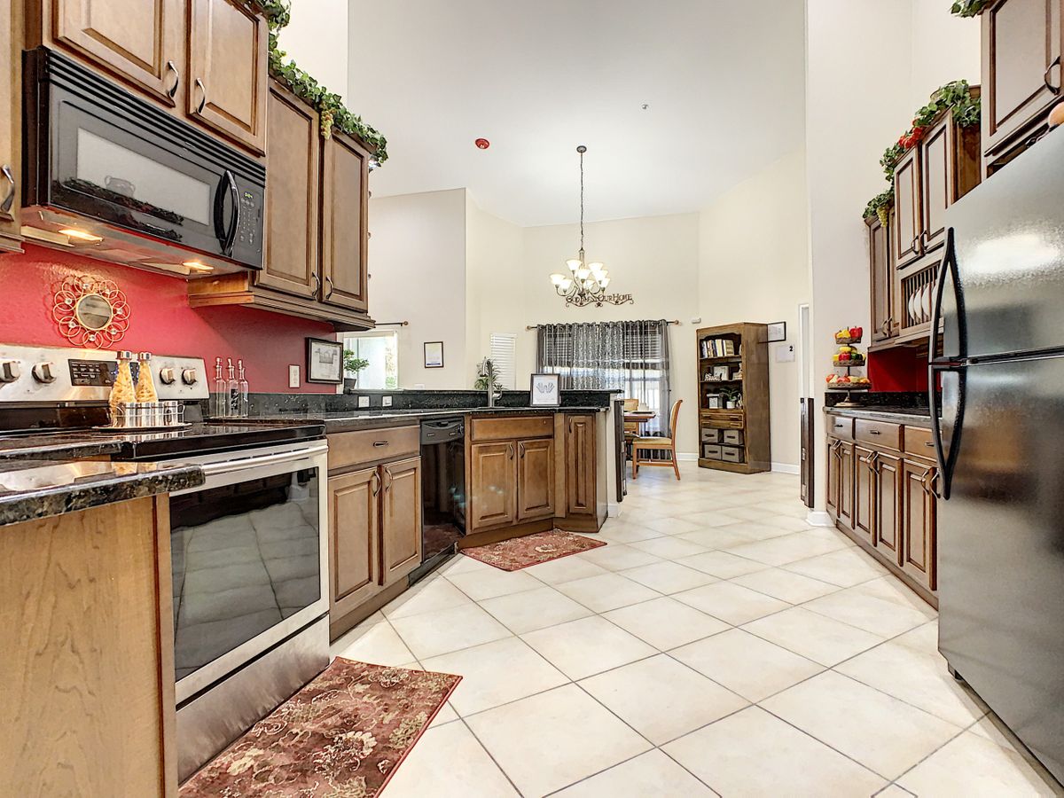 Spacious kitchen with wooden cabinets and a dining area.