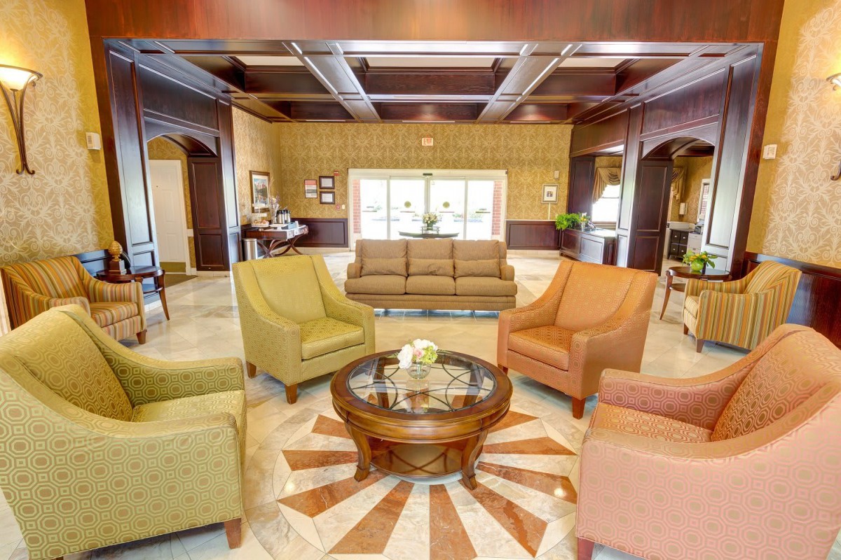 A well-decorated lobby with comfortable seating and a central coffee table.