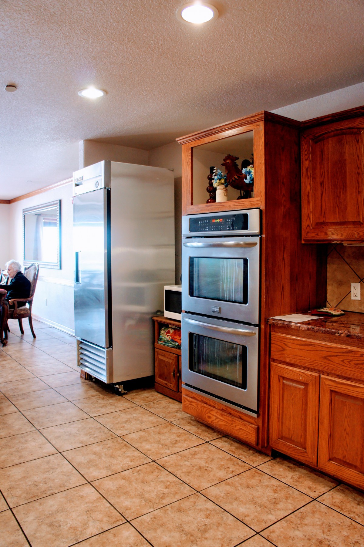 A spacious kitchen with stainless steel appliances and wood cabinetry.