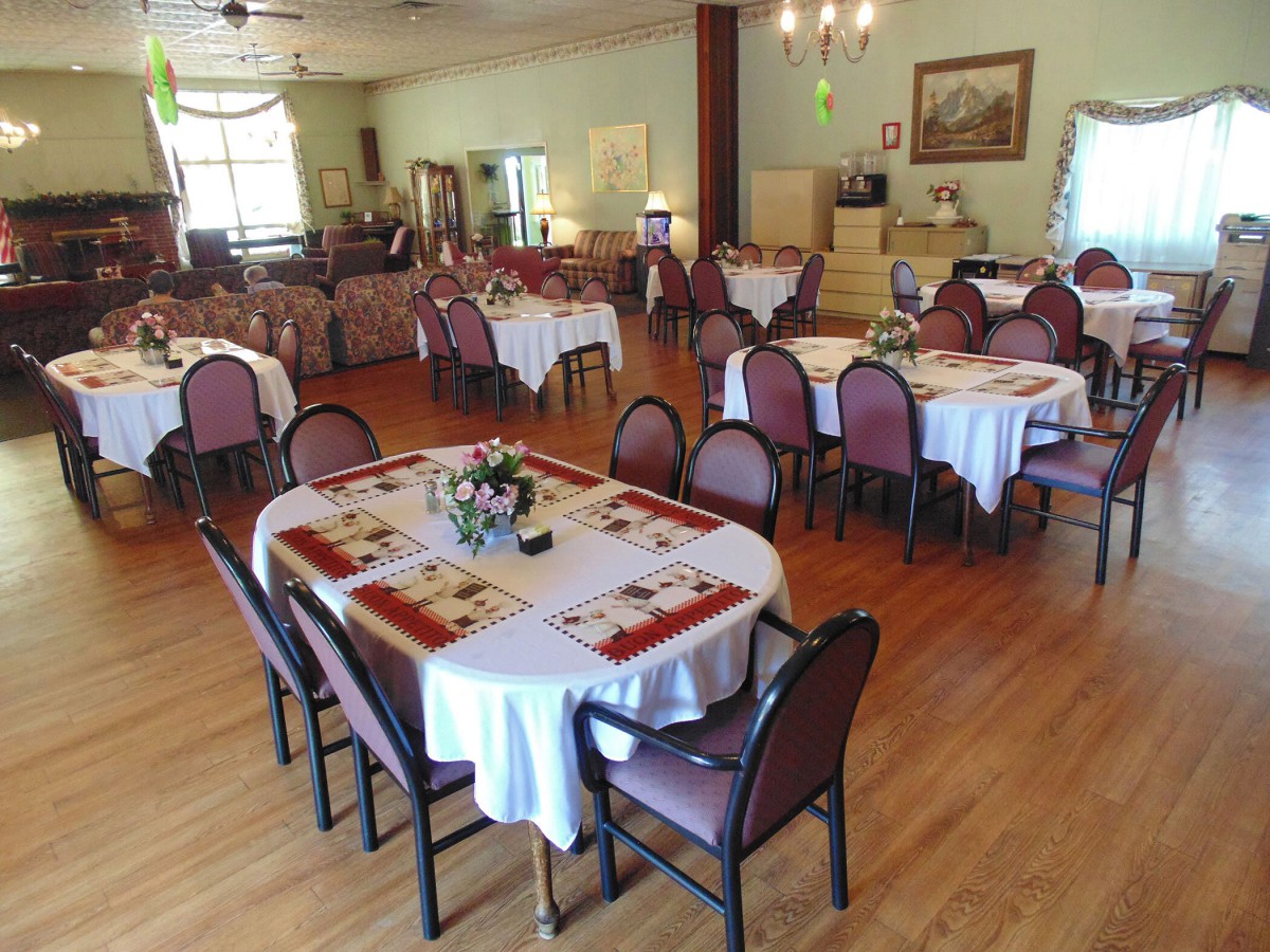 An elegantly arranged dining area with neatly set tables and chairs, ready to welcome guests.