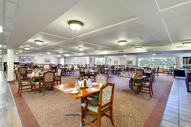 Spacious dining area with neatly arranged tables and chairs.