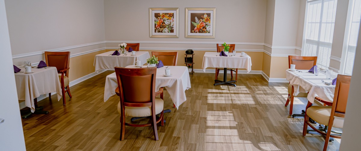 An elegant dining area with neatly arranged tables and chairs.