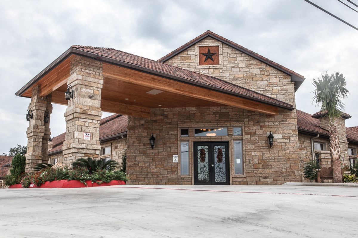 Stone building with a covered entrance and decorative star.
