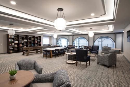 A modern library lounge with comfortable seating and ample lighting.