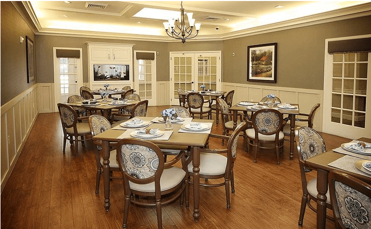 An elegant dining room with neatly arranged tables and chairs, featuring classic decor.