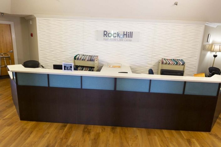 Reception area with a front desk and Rock Hill signage.