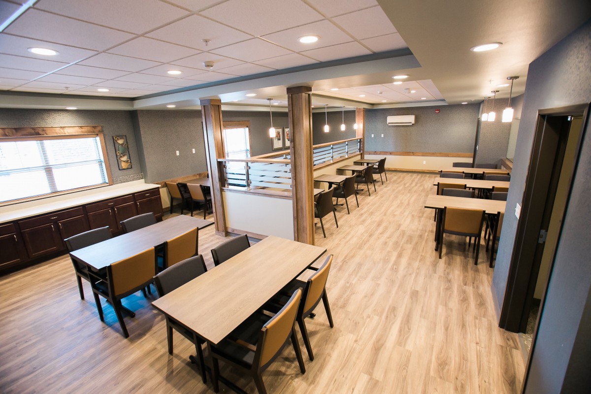 A spacious and modern dining area with neatly arranged tables and chairs.