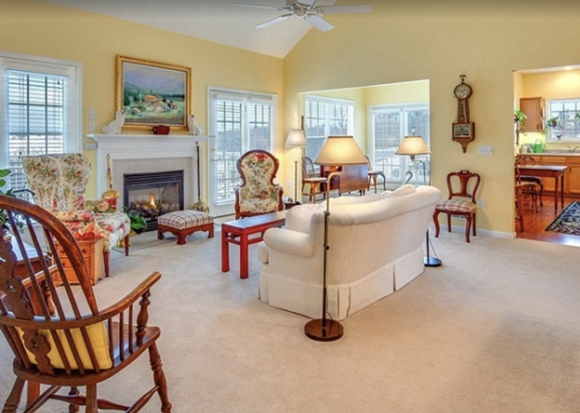 A cozy living room with traditional furniture and a fireplace.