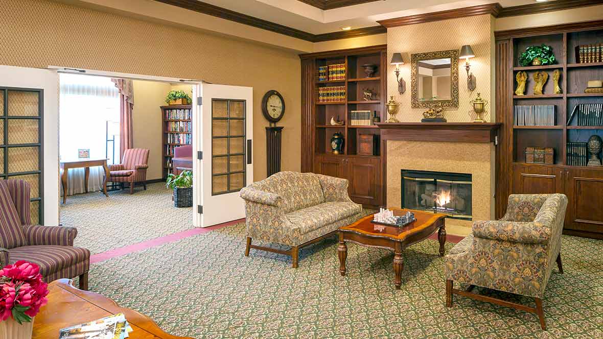 A cozy living room with a fireplace and comfortable seating.