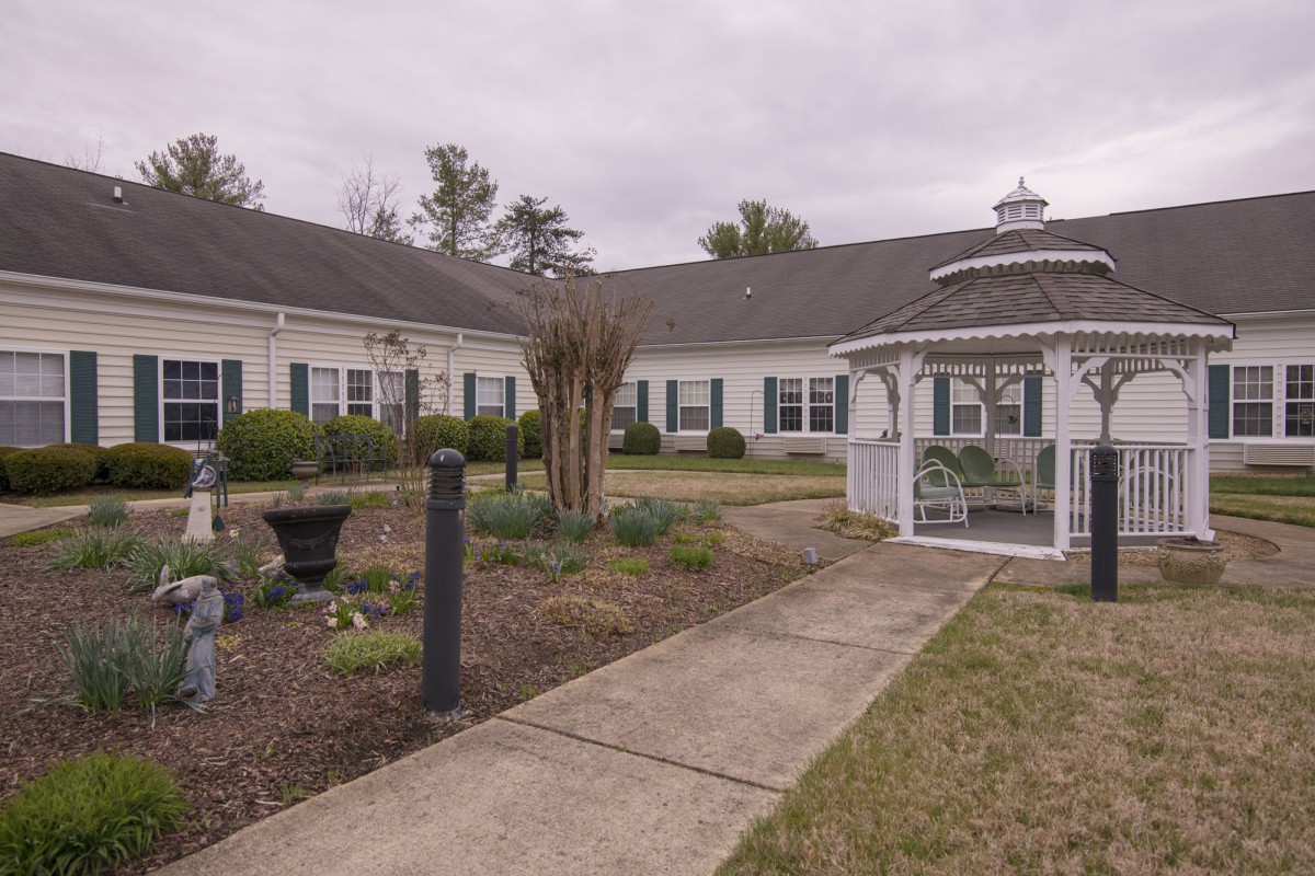 A scenic view of a building with a gazebo and landscaped garden area.