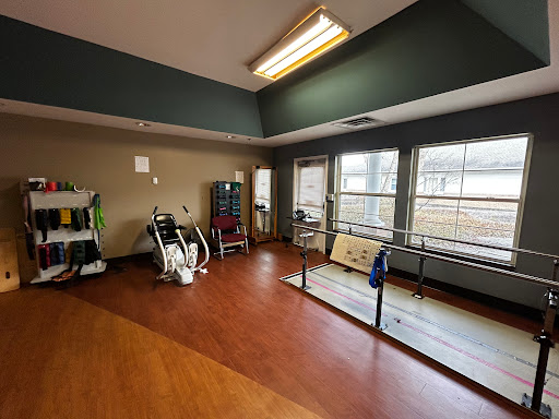A spacious rehabilitation area equipped with exercise machines and ample natural light.