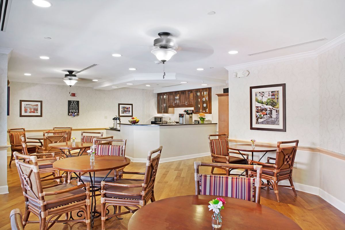 Spacious dining area with wooden tables and chairs, featuring a cozy atmosphere.