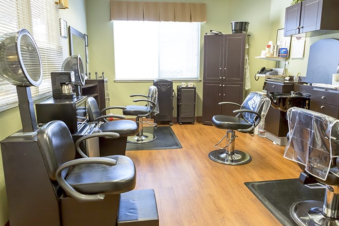 An interior view of a hair salon with multiple styling chairs and mirrors.