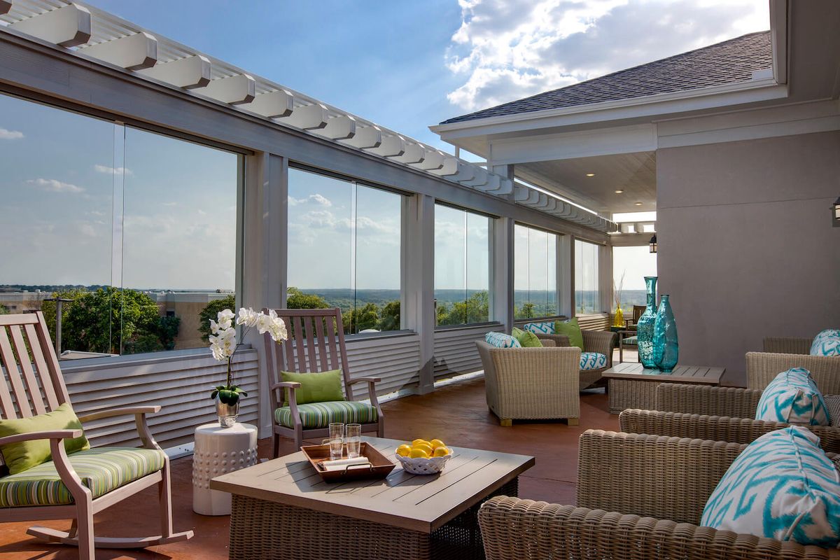 A well-furnished rooftop terrace with comfortable seating and a scenic view.