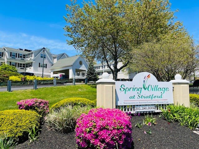 A scenic view of Spring Village at Stratford with vibrant flowers and well-maintained landscape.