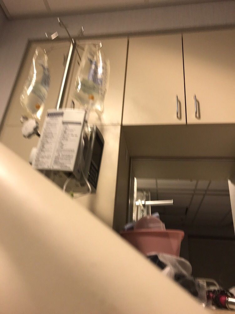 A hospital room with intravenous bags and medical equipment.