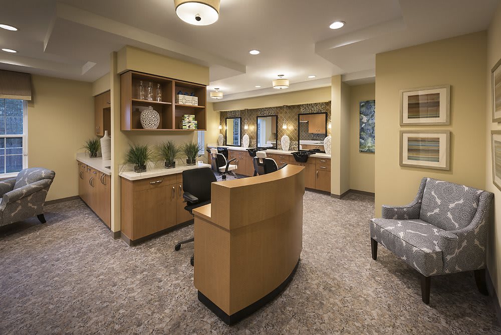 A modern reception area with stylish furniture and warm lighting.