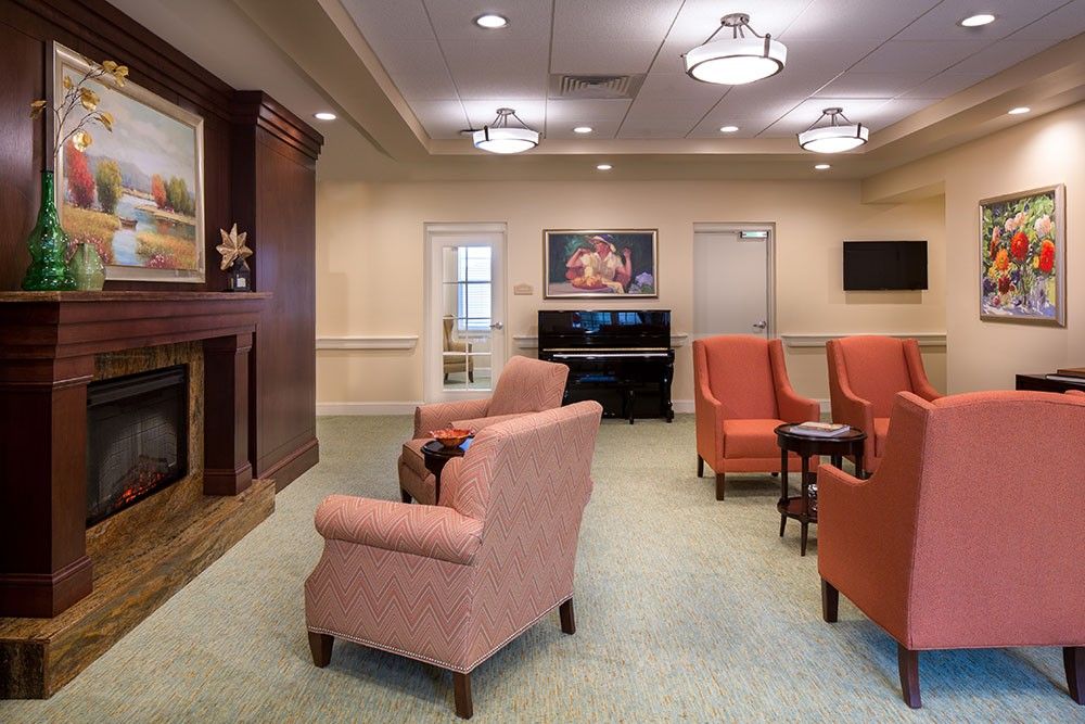 A cozy living space with comfortable seating and a piano.