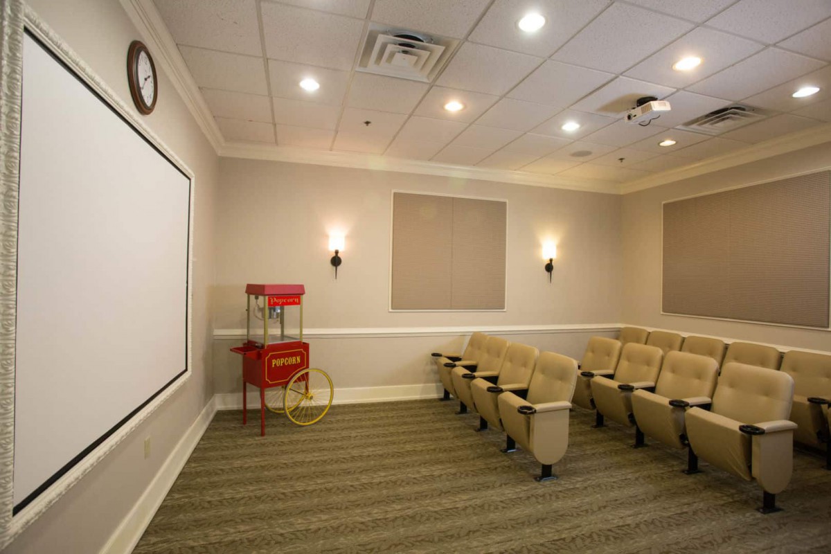 Cozy home theater setup with seating and a popcorn machine.