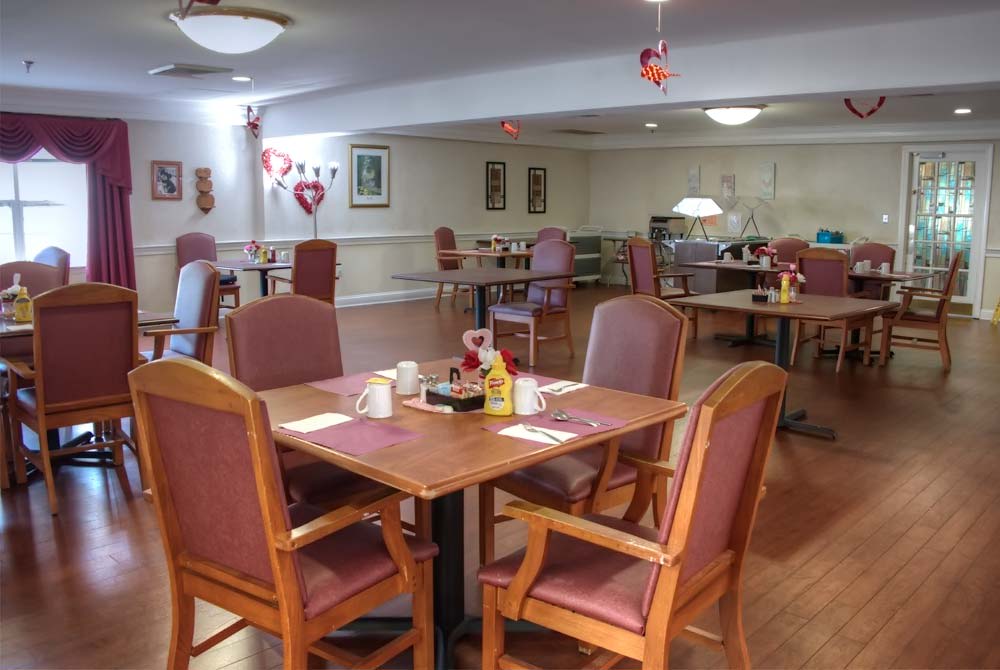 A cozy dining room with empty tables and chairs, elegantly decorated.