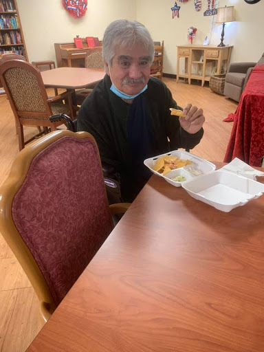 A person enjoying a meal at a dining table.