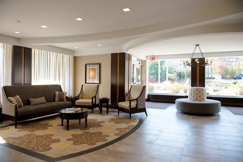A modern lobby with comfortable seating and large windows.