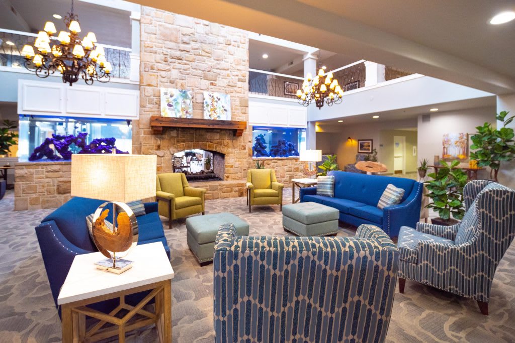 A stylish lobby with comfortable seating and a cozy fireplace.